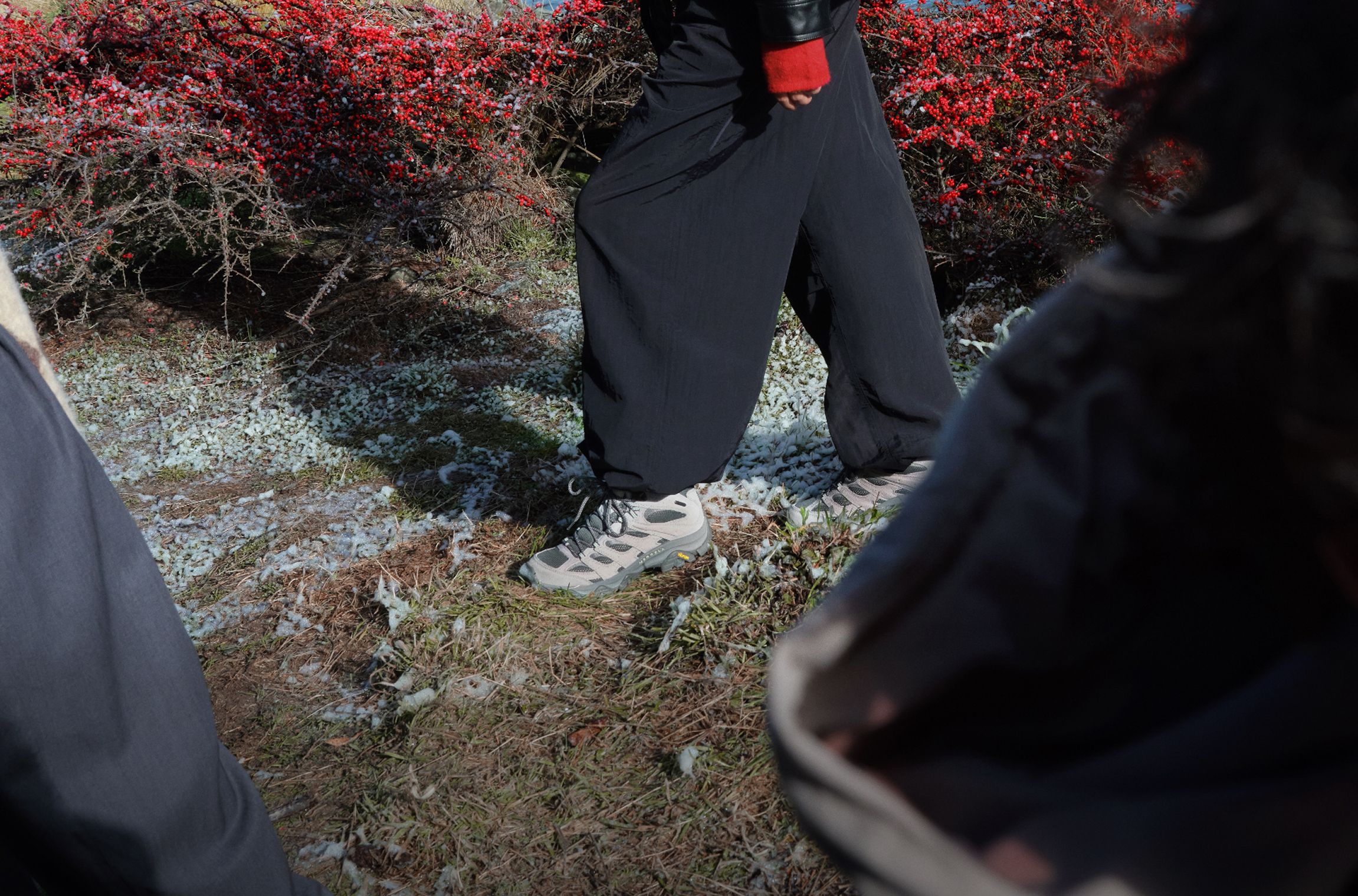 Merrell Moab 3 shoes worn on a lightly snow-covered trail.